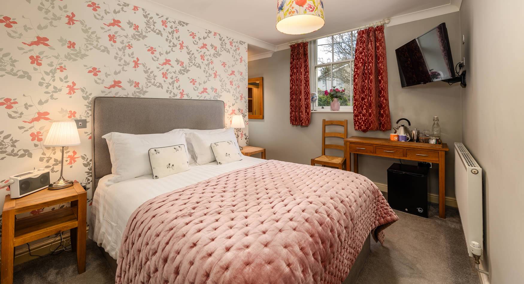 We have five beautiful rooms for you to stay in, so you can really make a night of it. Each one is individually styled, with lots of character and they are all named after past owners and landlords of the pub.  All our rooms are ensuite, with dreamy beds, gleaming bathrooms and carpets so plush your toes will sink into them. We have thoughtful touches too, things like homemade brownies, fresh coffee, proper milk, Roberts digital radios and Bath House toiletries, which are made in Cumbria.  Our room rates include a fabulous breakfast served 8.30- 10am – local bread, fresh fruit, cereals, yoghurt and a range of dishes including smoked salmon and scrambled eggs and a Full English.  Currently we do not allow pets in rooms, apart from in our brand new spacious Barn Annexe Apartment where your furry friends will be made more than welcome.